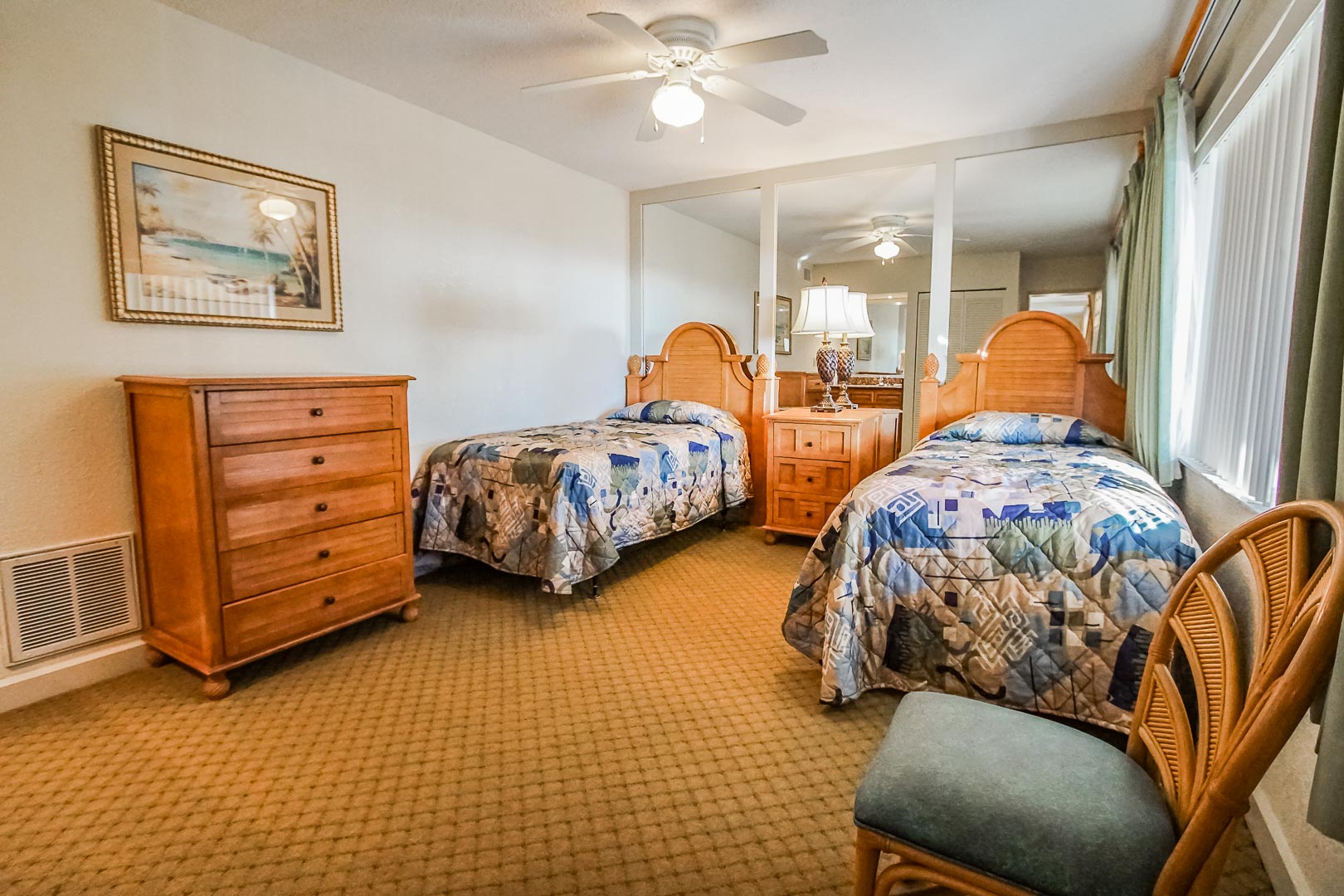 A bedroom with double beds at VRI's Coral Reef Beach Resort in St. Pete Beach, Florida.
